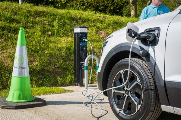 Parked EV being charged in car park